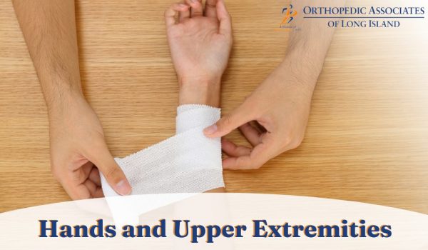 A person wraps a bandage around another person's wrist on a wooden surface, with text saying "Hands and Upper Extremities" and "Orthopedic Associates of Long Island.