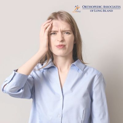 OALI LP (26) A woman in a light blue shirt touches her forehead with a pained expression The Orthopedic Associates of Long Island logo appears in the top right corner