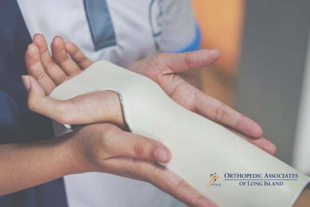 OALI LP (3) A medical professional fits a white splint to a patient's arm; the Orthopedic Associates of Long Island logo is visible in the corner